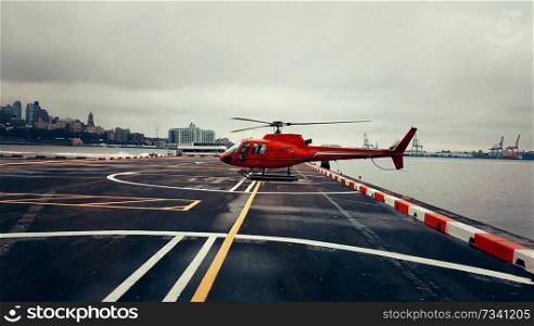 Helicopter used for sightseeing tours parked near Hudson River in New York City