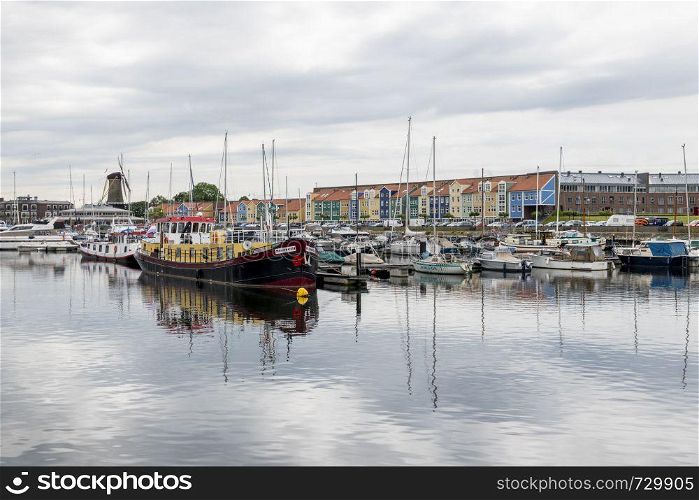 Hellevoetlsuis,15-june-2019:skyline of the old village of Hellevoetlsuis with the windmill and the boats in the harbor, this place was the old entrance to rotterdam. skyline of hellevoetsluis harbor