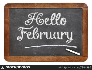 Hello February sign - white chalk text on an isolated vintage slate blackboard