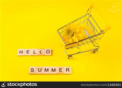 Hello summer. Colorful flowers on a yellow background. Vacation and seasonal shopping concept.. Hello summer. Colorful flowers on yellow background. Vacation and seasonal shopping concept.