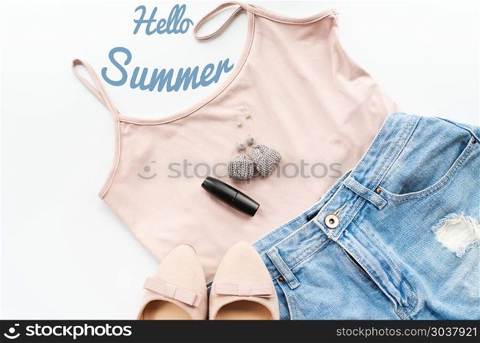 Hello summer concept. Female clothes, and accessories layout on . Hello summer concept. Female clothes, and accessories layout on white background. Flat lay. Top View