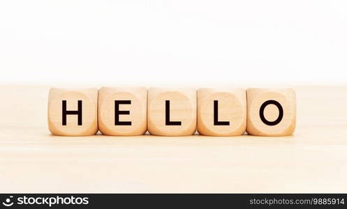 Hello word in wooden blocks on table. White background. Copy space