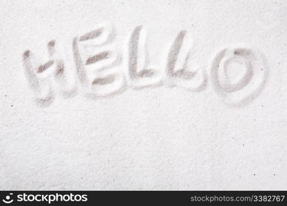 Hello written in beautiful white sand