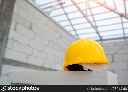 Helmet in construction site and construction site background safety first concept,Construction lightweight concrete concept.