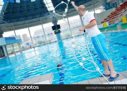 help and rescue action in swimming school at pool