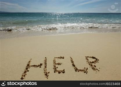Help Sign on the beach. Help Sign on the sand of tropical sea beach