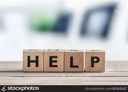 Help sign with cubes on a wooden table
