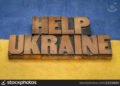 help Ukraine - words in vintage letterpress wood type against blue and yellow paper background in colors of Ukrainian national flag, support concept