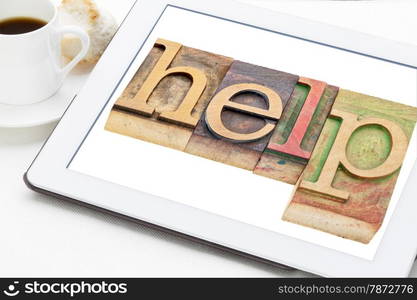 help word typography - text in letterpress wood type blocks on a digital tablet with a cup of coffee