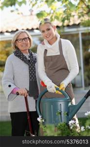 Helping elderly woman in the garden