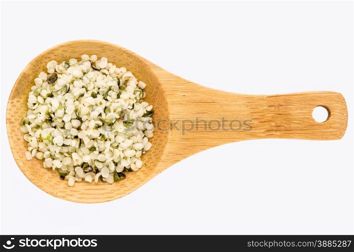 hemp seed hearts on a small wooden spoon isolated on white with a clipping path