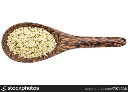 hemp seeds hearts on a wooden spoon isolated on white