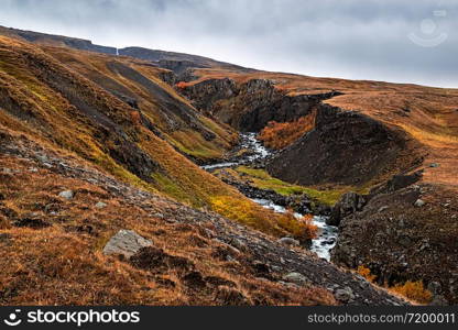 Hengifoss waterfall in eastside of Iceland in a cloudy day. Hengifoss waterfall, Iceland