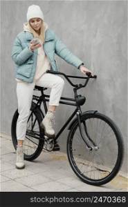 her bike using her mobile phone