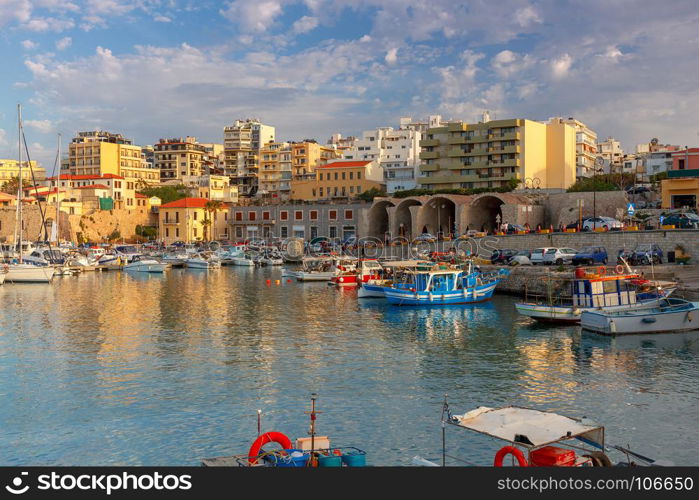 Heraklion. Fishing boats in the old port.. Fishing multi-colored boats in the old harbor of Heraklion in early sunny morning. Crete. Greece.