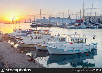 Heraklion. Fishing boats in the old port.. Fishing multi-colored boats in the old harbor of Heraklion in early sunny morning. Crete. Greece.