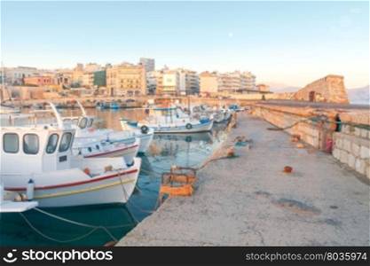 Heraklion. Fishing boats in the old port.. Fishing multi-colored boats in the old harbor of Heraklion in early sunny morning. Crete. Greece.