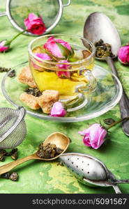 herb tea made from tea rose petals. rosebuds and a cup of herbal tea