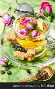 herb tea made from tea rose petals. rosebuds and a cup of herbal tea