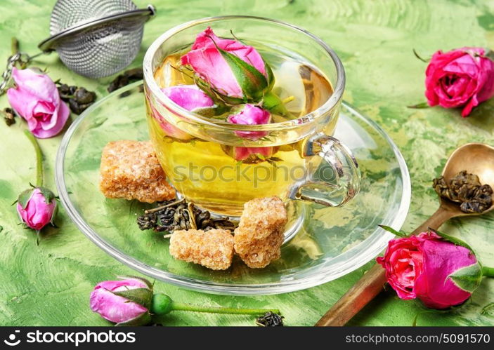 herb tea made from tea rose petals. rosebuds and a cup of herbal tea