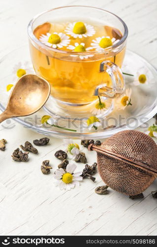 herb tea with fresh chamomile flowers. cup of herbal healthy tea with chamomile flowers