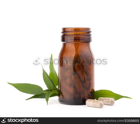 Herbal drug capsules in brown glass bottle isolated on white background cutout. Alternative medicine concept.