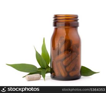 Herbal drug capsules in brown glass bottle isolated on white background cutout. Alternative medicine concept.
