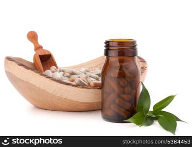 Herbal drug capsules in brown glass bottle isolated on white background cutout. Alternative medicine concept.