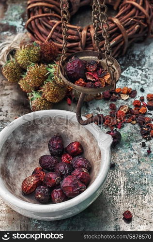 herbal medicine. assembled the dried yield healing herbs traditional medicine and ceramic mortar.Photo tinted.Selective focus