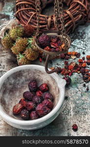 herbal medicine. assembled the dried yield healing herbs traditional medicine and ceramic mortar.Photo tinted.Selective focus