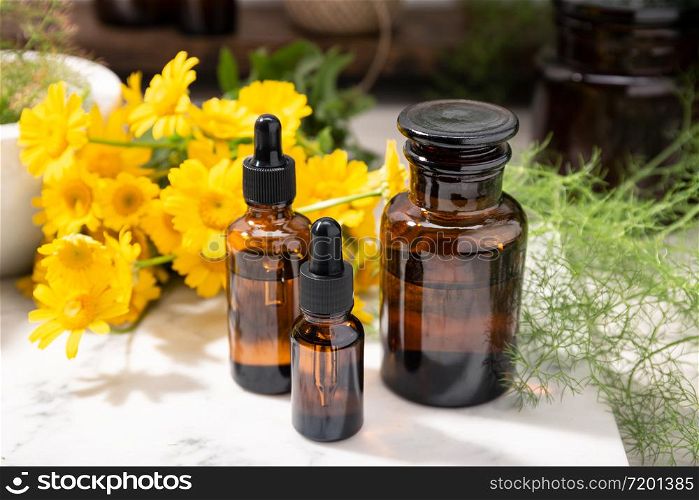 Herbal oil, essential oil, perfume on amber glass bottles. Natural beauty care products