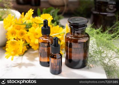 Herbal oil, essential oil, perfume on amber glass bottles. Natural beauty care products
