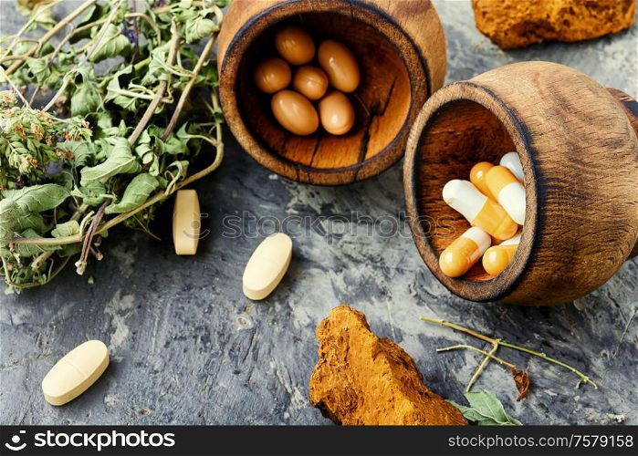Herbal pills with healthy healing plant.Capsule pill with herb. Medicine herbal pills