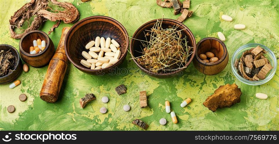 Herbal pills with healthy medical plant.Alternative medicine herbal and pills. Medical pills with healing herbs