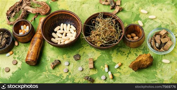 Herbal pills with healthy medical plant.Alternative medicine herbal and pills. Medical pills with healing herbs