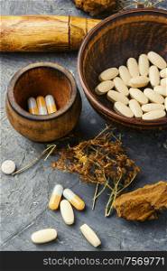 Herbal pills with healthy medical plant.Alternative medicine herbal and pills. Herbal capsules from herbs