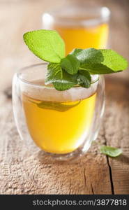 herbal sage tea with green leaf in glass cup