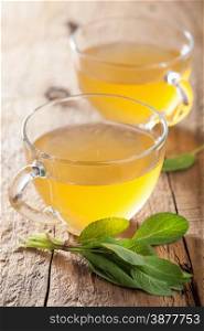 herbal sage tea with green leaf in glass cups