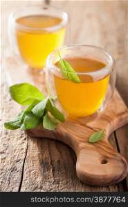 herbal sage tea with green leaves in glass cups