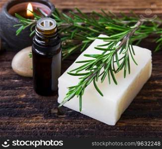 Herbal spa with rosemary soap, oil bottle and rosemary branches