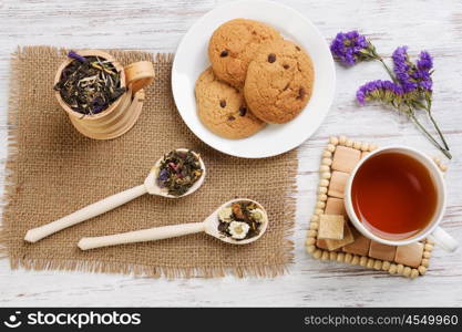 Herbal tea and cookies. Various kinds of herbal tea on wooden table