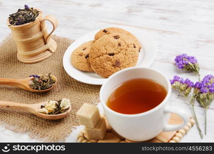 Herbal tea and cookies. Various kinds of herbal tea on wooden table