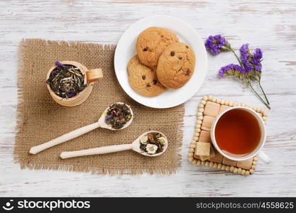 Herbal tea and cookies. Various kinds of herbal tea on wooden table