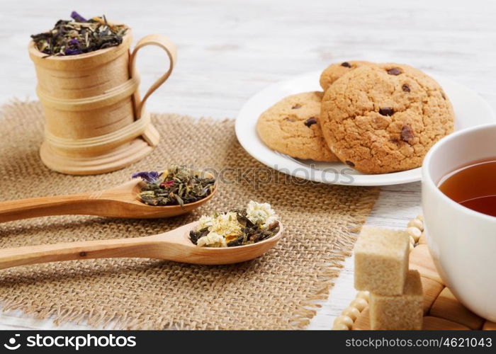 Herbal tea and cookies. Various kinds of herbal tea on wooden table