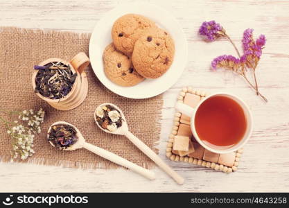 Herbal tea and cookies. Various kinds of herbal tea on wooden table