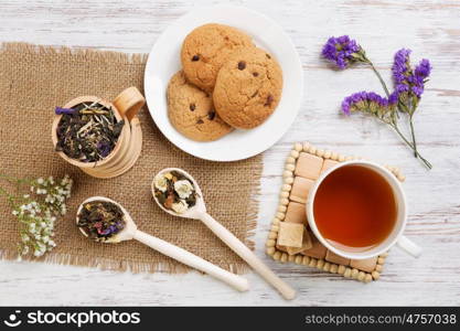 Herbal tea and cookies. Various kinds of herbal tea on wooden table