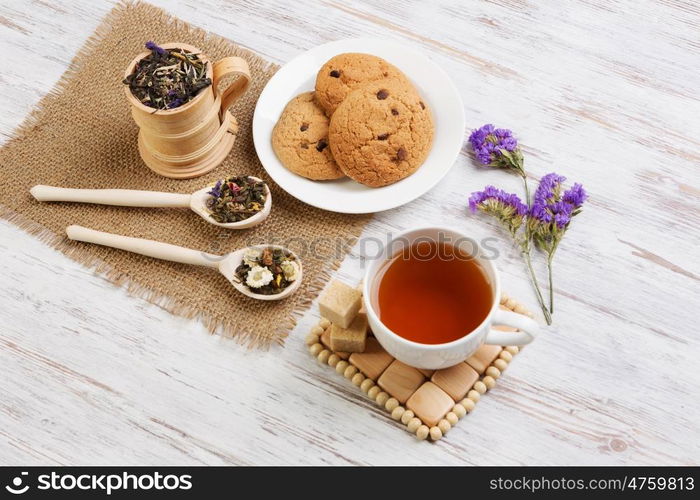 Herbal tea and cookies. Various kinds of herbal tea on wooden table