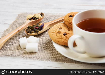 Herbal tea and cookies. Various kinds of herbal tea on wooden table