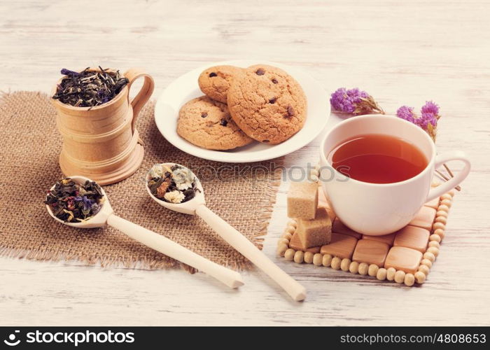 Herbal tea and cookies. Various kinds of herbal tea on wooden table