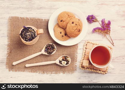 Herbal tea and cookies. Various kinds of herbal tea on wooden table